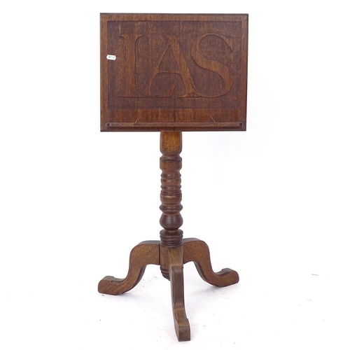 2236 - An Arts and Crafts oak music stand, the panel engraved with IAS