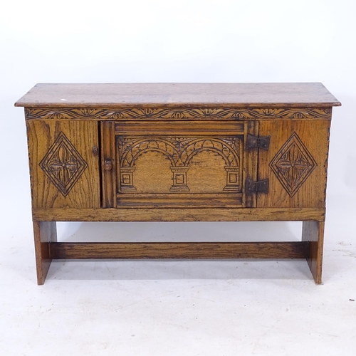 2245 - An Antique style low oak cabinet, with chip carved panelled front, W1047cm, H66cm, D38cm