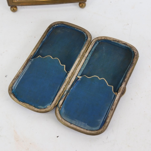 183 - An early 20th century blonde tortoiseshell cigarette case, and a brass photo frame, overall height 2... 