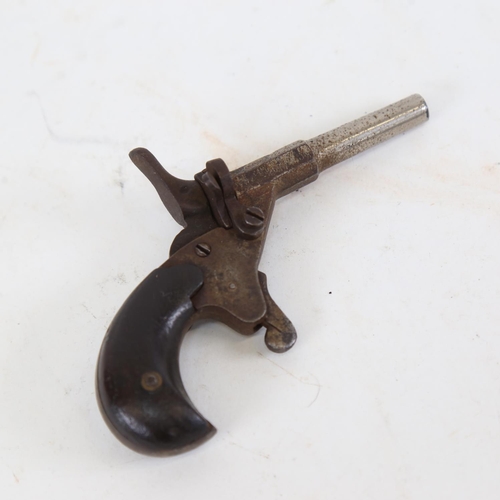 186 - A miniature starting pistol, with wood grips, overall length 11cm