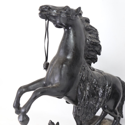 238 - A pair of black painted spelter Marley horse groups, on ebonised bases, overall height 44cm (2)