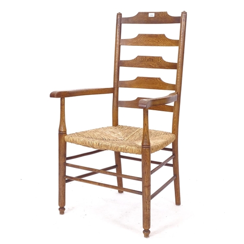 2362 - A Clissett style Cotswold School Arts and Crafts armchair, with rush seat