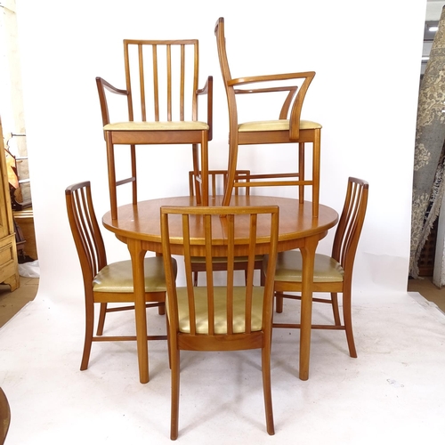 2254 - A mid-century teak dining room suite, comprising an oval extending dining table, together with a set... 