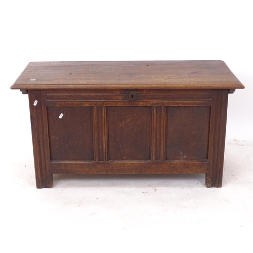 2261 - An 18th century joined oak coffer, with panelled front and stile legs, W107cm, H54cm, D45cm