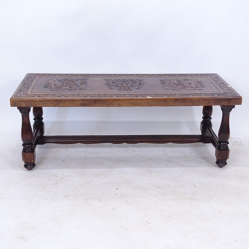 2277 - A rectangular oak coffee table, with a tooled embossed leather top, raised on baluster legs, L121cm,... 