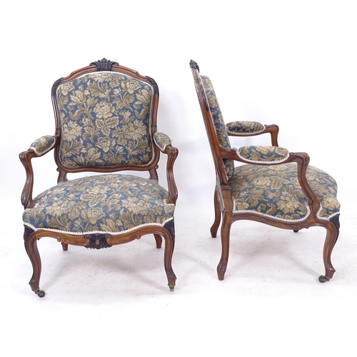 2280 - A pair of French walnut-framed open-arm chairs, with blue and gold upholstery, on cabriole legs