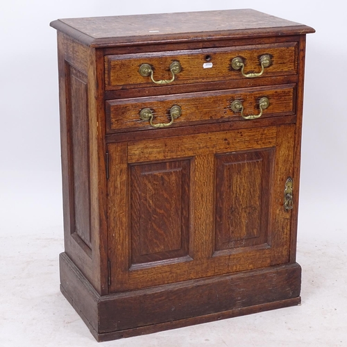 2330 - A centre standing panelled oak cabinet, with 2 frieze drawers, and cupboards under, W62cm, H79cm, D3... 