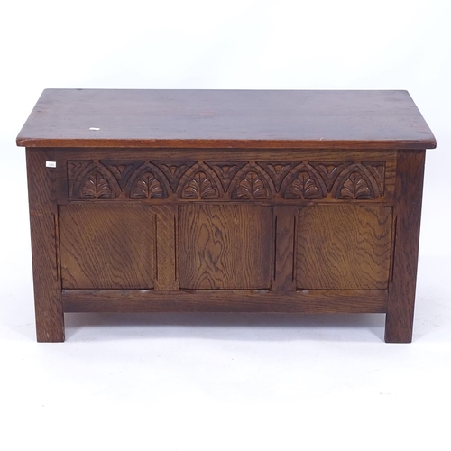 2196 - A carved and panelled oak coffer, on stile legs, W92cm, H50cm, D44cm