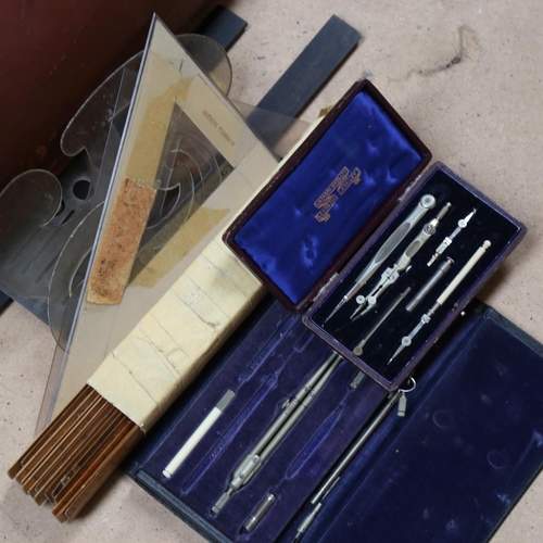 444 - A leather case containing drawing instruments and rulers, a set square, and a drawing board