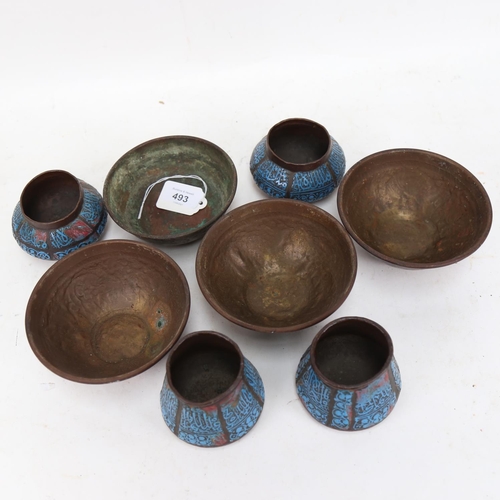 493 - A set of 4 copper pots with embossed design of animals, and a set of 4 copper pots with blue enamell... 