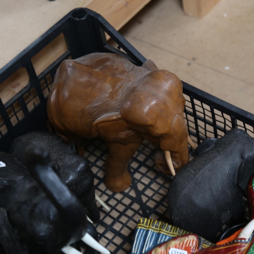 502 - A group of carved elephants, an ebony dressing table set, and a mask