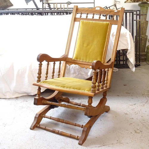 2511 - An American carved and upholstered rocking chair