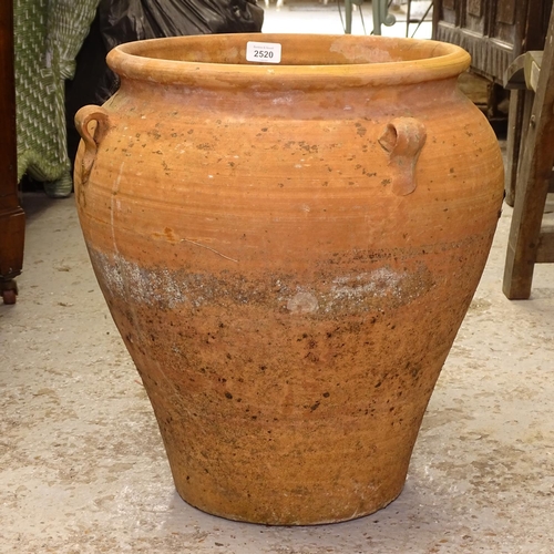 2520 - A 4-handled terracotta oil jar, W40cm, H46cm