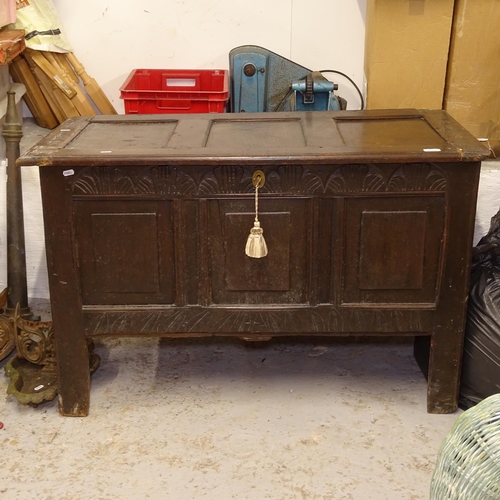 2526 - An 18th century joined oak coffer, with a carved and panelled front on stile legs, W112cm, H71cm, D5... 