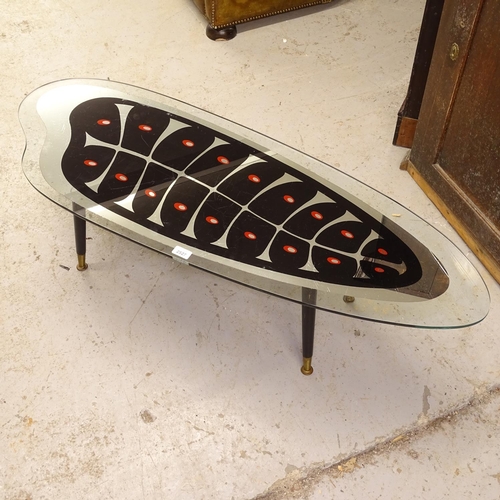 2527 - A mid-century glass-top coffee table, with painted design, on dansette legs, L121cm, H34cm