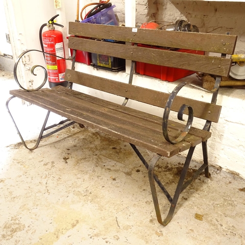 2538 - A hardwood slatted garden bench, on scrolled wrought-iron frame, L126cm