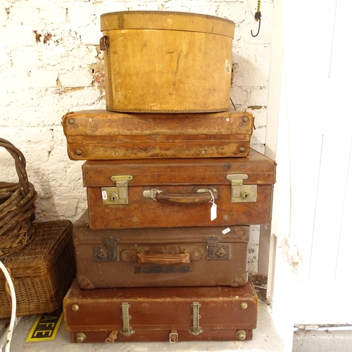 2540 - A collection of leather-covered and cardboard suitcases, and a bentwood hat box