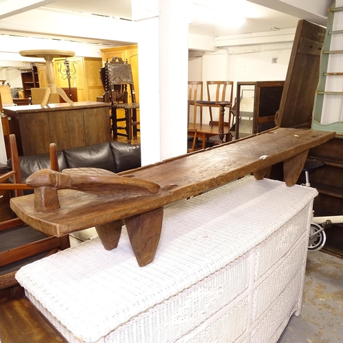 2555 - An African Senufo carved day bed/bench, L185cm