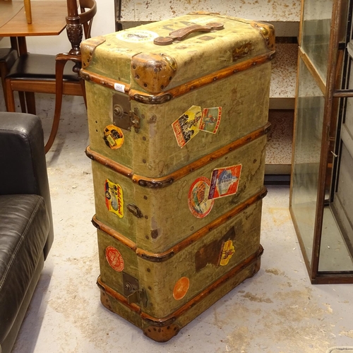 2586 - An early 20th century slat and leather-bound travelling trunk, with labels, W90cm