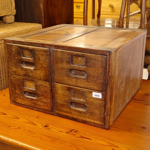 2600 - A 1920s oak 4-section index filing cabinet, W52cm, H33cm, D51cm