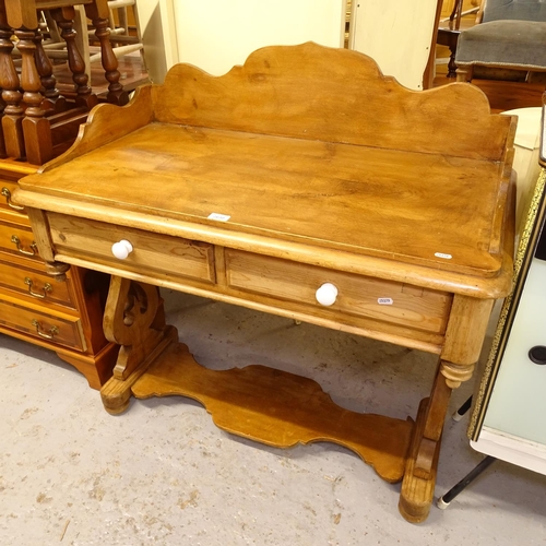 2630 - A pine washstand with shaped raised back, and 2 frieze drawers, on pierced lyre supports, W101cm, H1... 