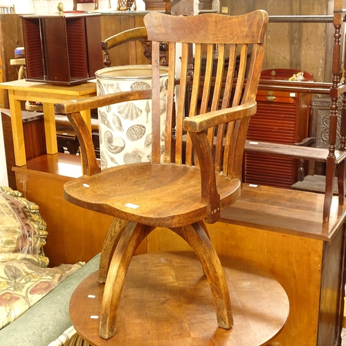 2643 - An early 20th century oak swivel desk chair