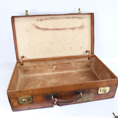 324 - A Victorian leather suitcase, with brass English lever locks