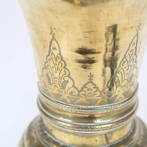 517 - An Eastern brass vase, with embossed decoration, height 38cm