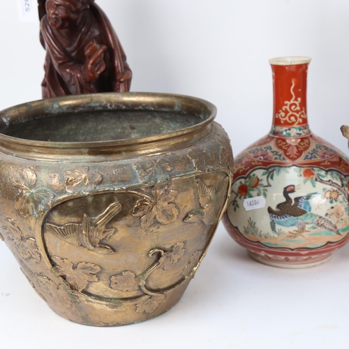 520 - Carved hardwood Oriental figures, a vase (A/F), a Tang style horse, and an embossed metal pot with b... 