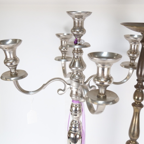 529 - A turned brass pricket candlestick, 74cm, and a polished metal candelabrum