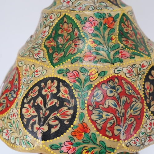 556 - A table lamp with painted floral panels, and matching painted skin(?) shade, height 55cm