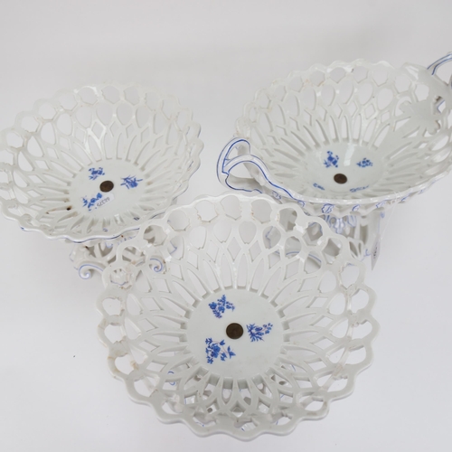 557 - A pierced porcelain 2-handled comport, height 24cm, and a pair of matching white and blue pierced co... 