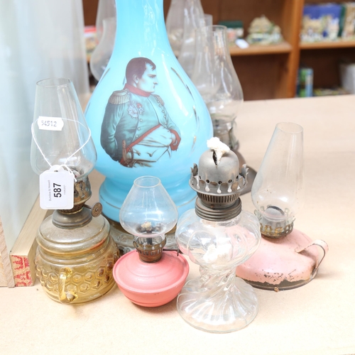 587 - A Victorian blue glass oil lamp with Napoleon print, height 80cm, and 10 small oil lamps