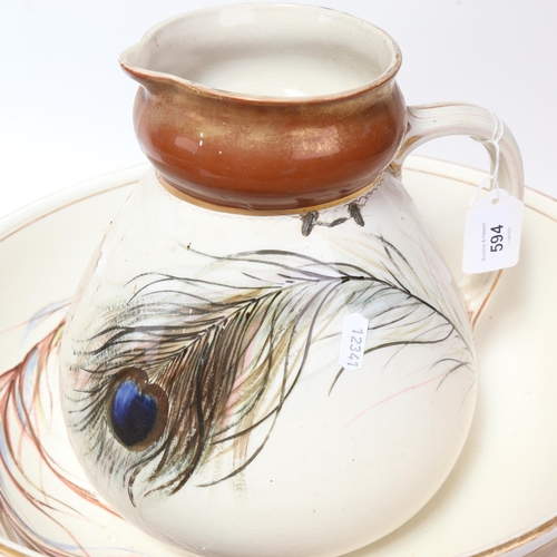 594 - A pestle and mortar, and a Victorian pottery wash jug and basin with painted peacock feather design