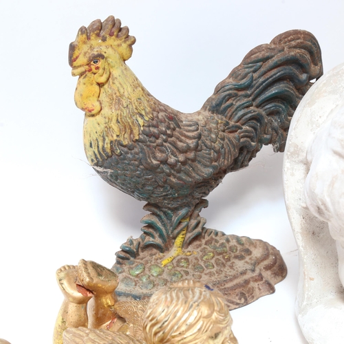 596 - A painted cast-iron chicken doorstop, a pair of cherubs, a plaster boy's head, a taxidermic case shr... 