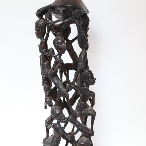 601 - A large African hardwood carving of figures from a single piece of wood, height 75cm