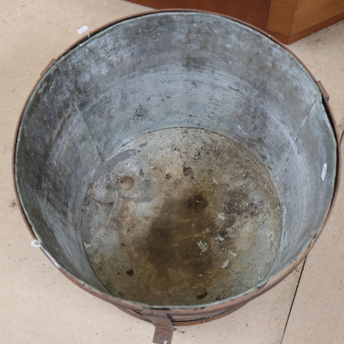 626 - A copper pot in iron stand, height 43cm