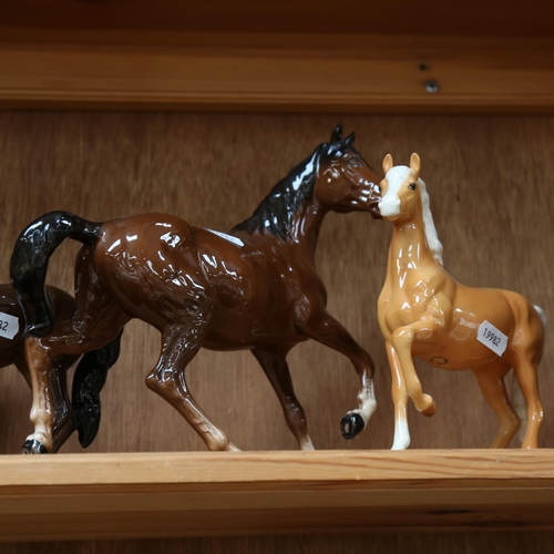 662 - A group of Beswick horses, including Black Beauty and foal