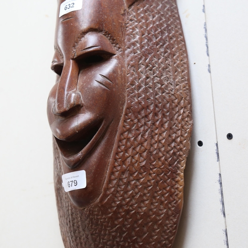 679 - A carved hardwood mask, 62cm