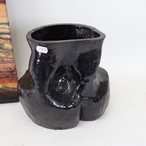 715 - A heavy clay pot of abstract form, height 20cm, and a painted pottery panel stylised landscape