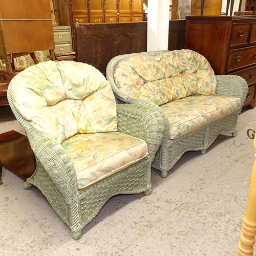 2652 - A green wicker conservatory settee, and matching armchair, with loose cushions