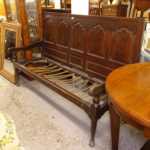 2657 - An 18th century joined oak settle, with a fielded panelled back, on cabriole legs, L183cm (no seat)