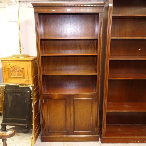 2670 - A reproduction mahogany open bookcase, with 3 adjustable shelves and cupboards under, W85cm, H182cm,... 