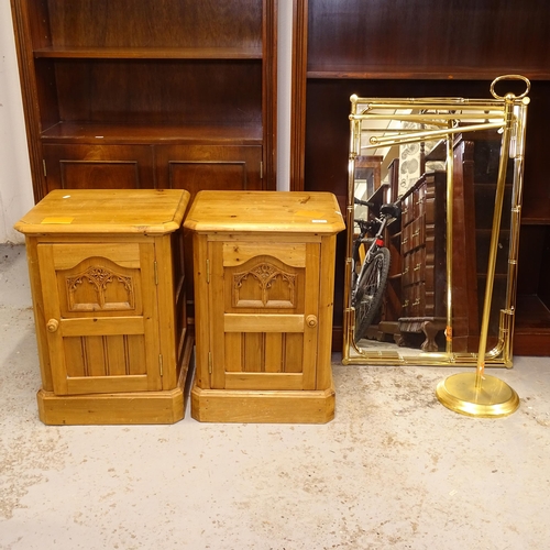 2673 - A pair of pine bedside cupboards, a brass-effect framed wall mirror, and a brass-effect towel rails