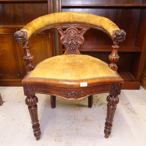 2678 - A Victorian oak and leather-upholstered bow-arm desk chair, with carved arms, on fluted legs