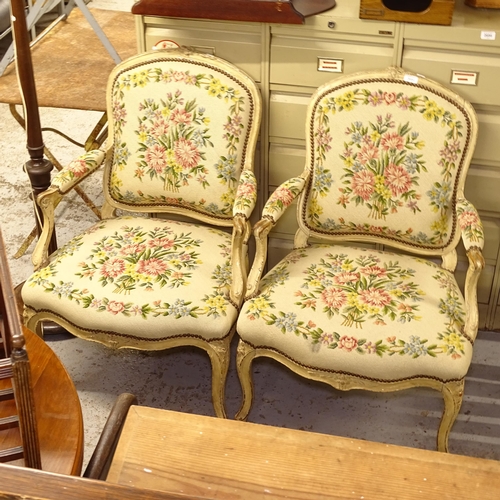 2684 - A pair of French cream-painted open-arm bedroom chairs, with studded floral upholstery