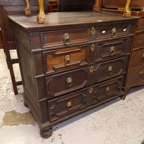 2701 - A 17th century style oak chest, the 2 short and 3 long drawers having moulded fronts, with lion mask... 