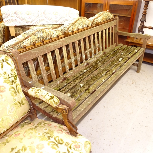 2738 - A weathered hardwood slatted garden bench, L183cm