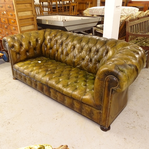 2742 - A Victorian horsehair and allover studded leather upholstered rollover arm Chesterfield settee, on h... 