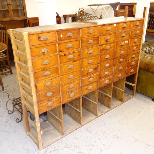 2743 - A Vintage pine bank of 42 pitch pine drawers, with open shelves under, L184cm, H130cm, D40cm